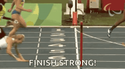 A Woman Is Falling On A Track While Running And The Words Finish Strong Are Visible . GIF