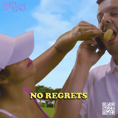 A Woman Is Feeding A Man A Piece Of Fruit With The Words No Regrets Written Below Her GIF
