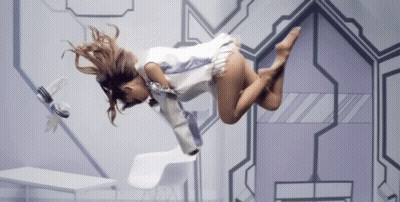 A Woman Is Flying Through The Air In A Futuristic Setting GIF