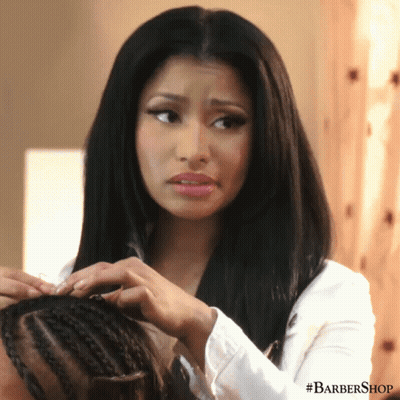 A Woman Is Getting Her Hair Braided By A Barber Shop GIF