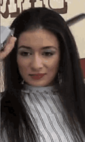 A Woman Is Getting Her Hair Cut By A Barber In A Barber Shop . GIF