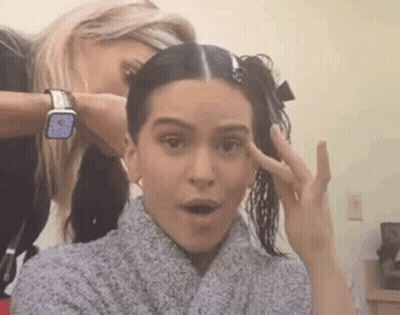 A Woman Is Getting Her Hair Cut By A Hairdresser While Another Woman Looks On . GIF