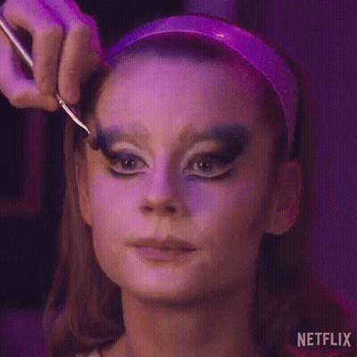 A Woman Is Getting Her Makeup Done By A Makeup Artist With A Brush . GIF