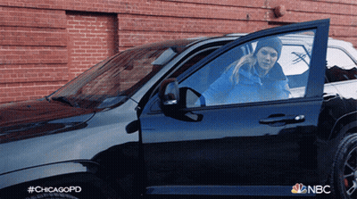 A Woman Is Getting Out Of A Nbc Chicago Police Car GIF