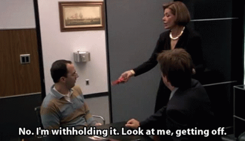 A Woman Is Giving A Man A Piece Of Paper That Says No I 'M Withholding It GIF