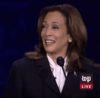 a woman is giving a speech in front of a microphone with wp live written on it