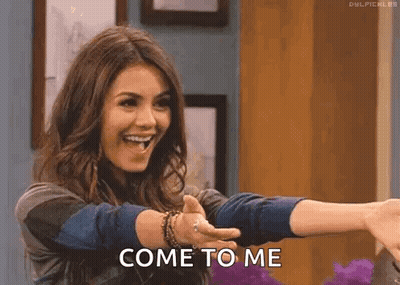 A Woman Is Giving A Thumbs Up And Smiling While Holding Out Her Arms And Saying Come To Me . GIF