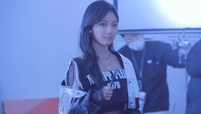 A Woman Is Giving A Thumbs Up In A Room . GIF