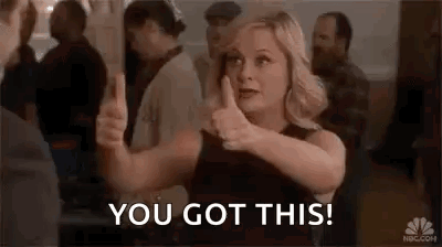 A Woman Is Giving A Thumbs Up Sign In Front Of A Crowd . GIF