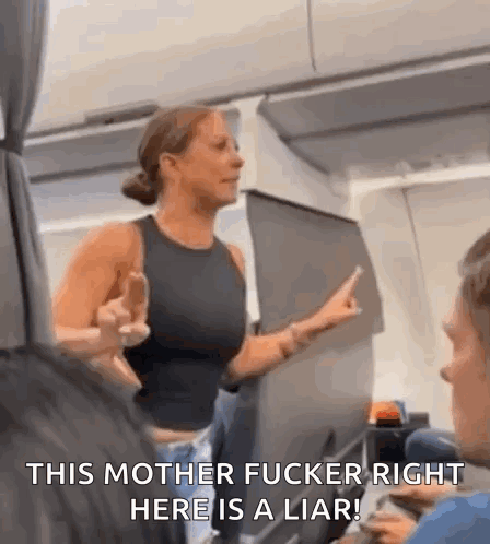 A Woman Is Giving The Middle Finger On An Airplane While Talking To A Man . GIF