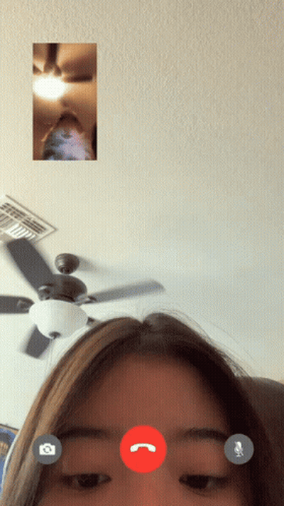 A Woman Is Having A Video Call With Another Person With A Ceiling Fan In The Background GIF