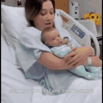 A Woman Is Holding A Baby In A Hospital Bed With The Words Me Trying To Escape This Timeline Below Her GIF
