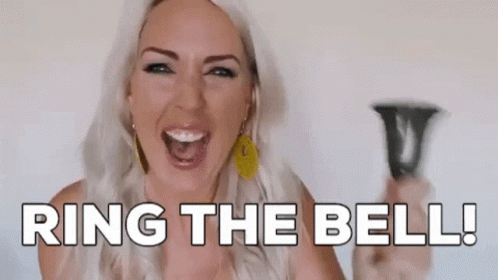 A Woman Is Holding A Bell In Her Hand And Saying `` Ring The Bell '' . GIF