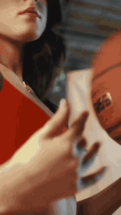 A Woman Is Holding A Book And A Basketball GIF