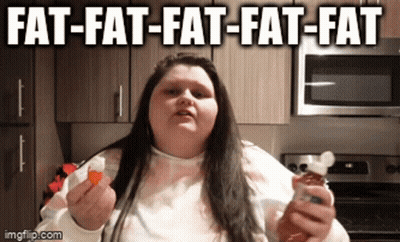 A Woman Is Holding A Bottle Of Hot Sauce And A Slice Of Bread With The Caption Fat-Fat-Fat GIF
