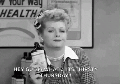 A Woman Is Holding A Bottle Of Medicine And Saying `` Hey Guess What ... It 'S Thirsty Thursday '' . GIF