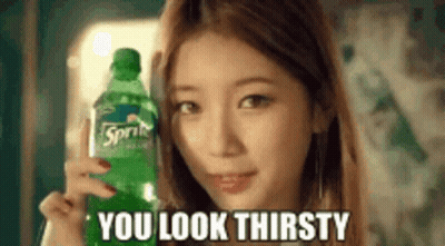 A Woman Is Holding A Bottle Of Sprite In Her Hand And Says `` You Look Thirsty '' . GIF