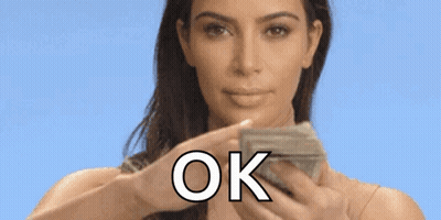 A Woman Is Holding A Bunch Of Money In Her Hands And Saying Ok . GIF