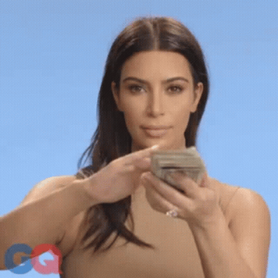 A Woman Is Holding A Bunch Of Money In Her Hands And Throwing It In The Air . GIF