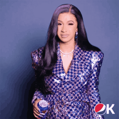 A Woman Is Holding A Can Of Pepsi In Her Hand GIF
