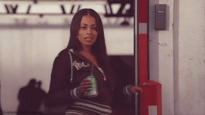 A Woman Is Holding A Can Of Soda And Wearing A Hoodie That Says Rica GIF