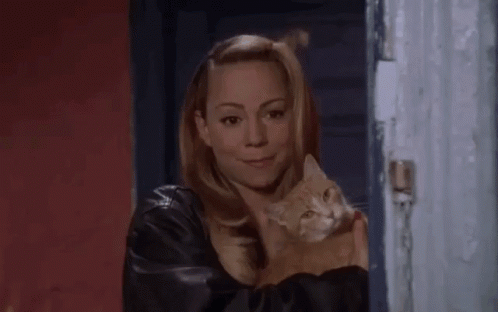 A Woman Is Holding A Cat In Her Arms And Says Hi GIF