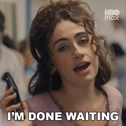 A Woman Is Holding A Cell Phone And Says I 'M Done Waiting . GIF