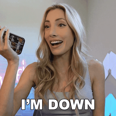A Woman Is Holding A Cell Phone And Says " I 'M Down " In White Letters GIF