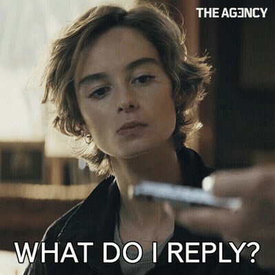 A Woman Is Holding A Cell Phone And Says " What Do I Reply " On The Bottom GIF