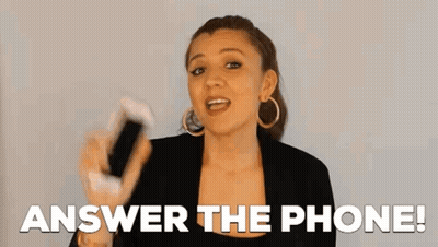 A Woman Is Holding A Cell Phone In Her Hand And Says `` Answer The Phone '' . GIF