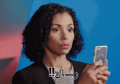 A Woman Is Holding A Cell Phone With A Sticker That Says Pm GIF