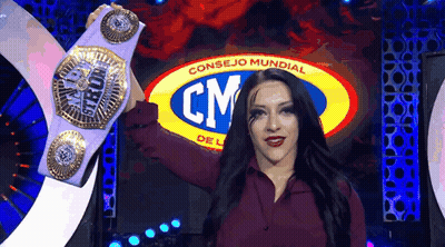 A Woman Is Holding A Championship Belt In Front Of A Cm Logo . GIF