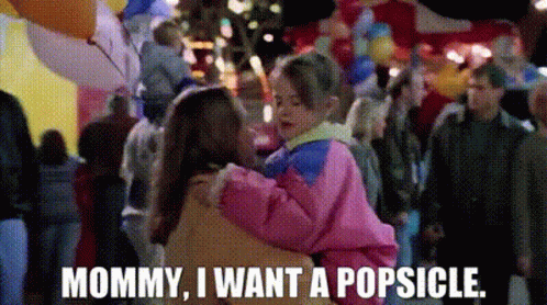 A Woman Is Holding A Child In Her Arms And Says Mommy I Want A Popsicle GIF