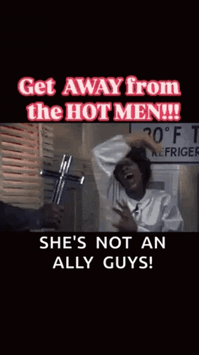 A Woman Is Holding A Cross In Front Of A Sign That Says Refrigerator GIF