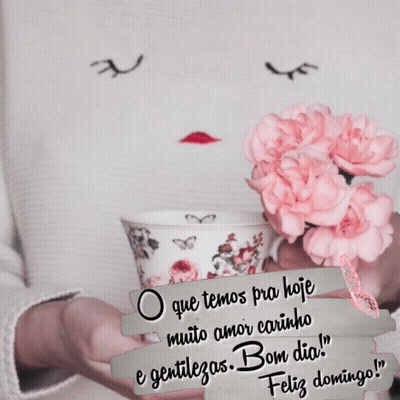 A Woman Is Holding A Cup Of Coffee With Pink Flowers In Her Hands GIF