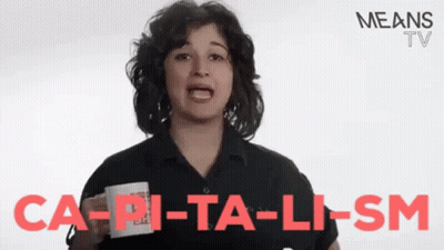 A Woman Is Holding A Cup With The Words Ca-Pi-Ta-Li-Sm Written On It GIF