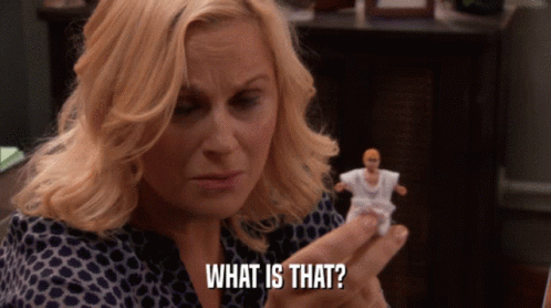 A Woman Is Holding A Doll And Says What Is That GIF