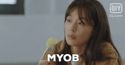 A Woman Is Holding A Fork And Eating A Piece Of Food . GIF