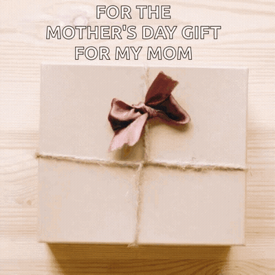 A Woman Is Holding A Gift Box With A Brown Bow On It . GIF
