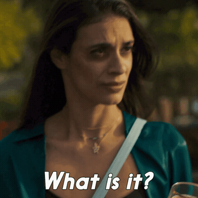 A Woman Is Holding A Glass Of Beer And Asking What Is It GIF