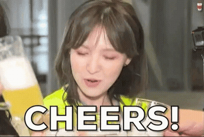 A Woman Is Holding A Glass Of Beer And Making A Cheers Gesture . GIF