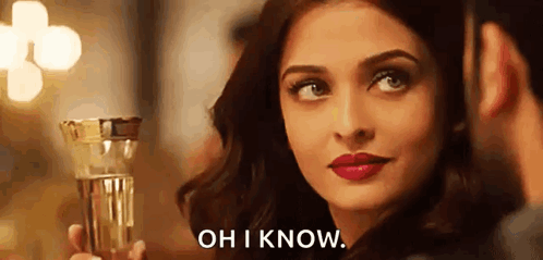 A Woman Is Holding A Glass Of Water And A Man Is Looking At Her . GIF