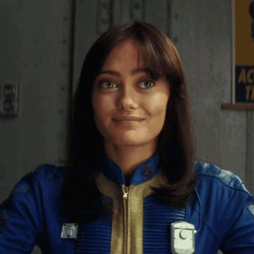 A Woman Is Holding A Gun In Front Of A Sign That Says Ac Tf GIF