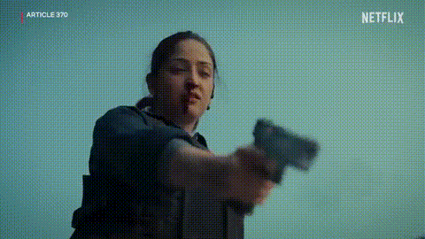 A Woman Is Holding A Gun In Her Hand In A Netflix Trailer . GIF