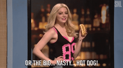 A Woman Is Holding A Hot Dog And Says Or The Big Nasty Hot Dog GIF