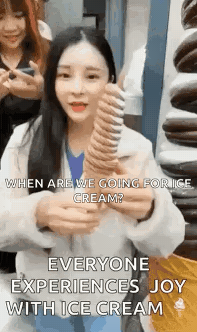 A Woman Is Holding A Large Ice Cream Cone And Asking When Are We Going For Ice Cream . GIF