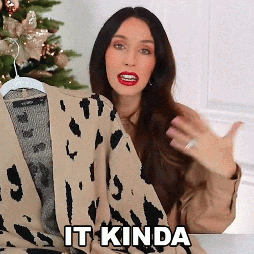 A Woman Is Holding A Leopard Print Sweater And Saying It Kinda GIF