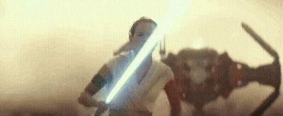 A Woman Is Holding A Light Saber In Front Of A Robot In A Star Wars Movie . GIF
