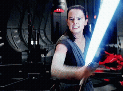 A Woman Is Holding A Light Saber In Her Right Hand GIF