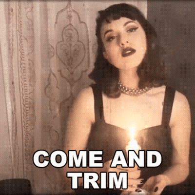 A Woman Is Holding A Lit Candle With The Words Come And Trim Written Above Her GIF